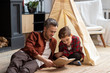 © deniskomarov - father and son spend time together read book