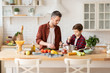© deniskomarov - Father and son cooking in the kitchen