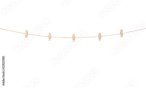 Fotomural Wooden clothes pins hanging on brown rope isolated on white background