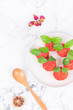 © chen - Red dessert like litchi on a white plate