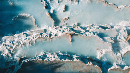 Woman relaxing at natural hot springs at Saturnia, Tuscany, Italy