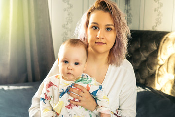 Wall Mural - Happy young mother with baby.