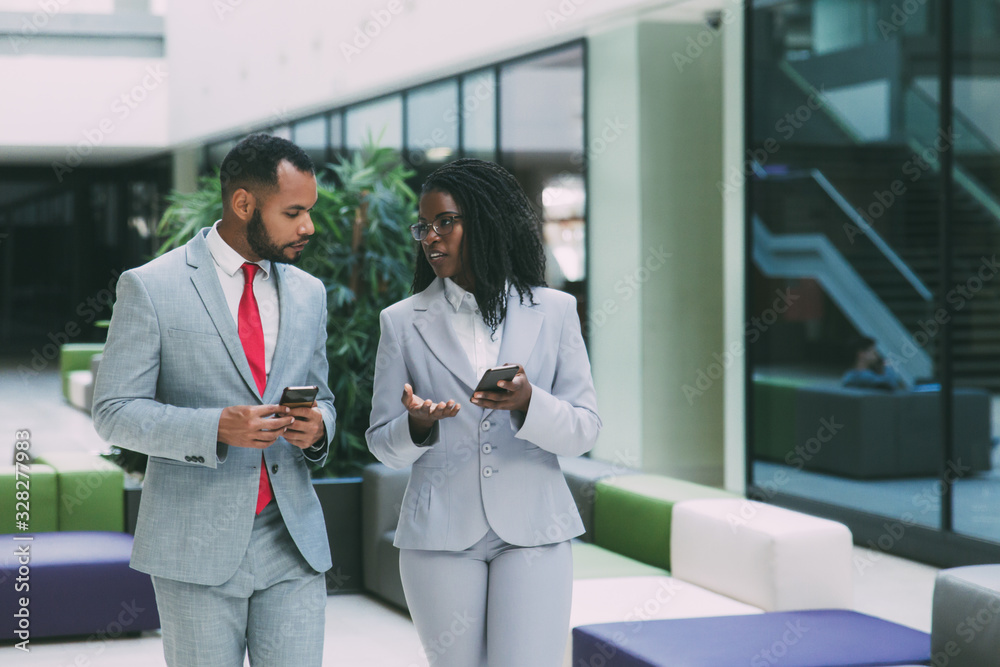 Person Using Phone Professional Diverse business professionals using mobile phones and discussing work ...
