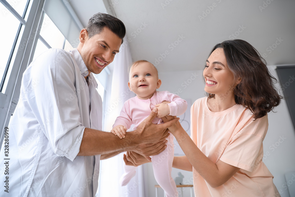 Cute baby with parents at home