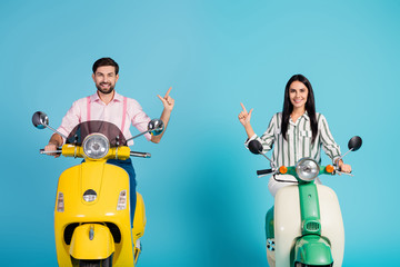 Sticker - Positive cheerful two people driver drive yellow green motor bike follow way to resort point index finger copyspace wear formalwear shirt isolated over blue color background