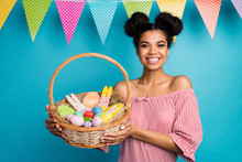 Photo Of Pretty Dark Skin Lady Hold Holiday Basket Came Family Easter Dinner Eggs Ginger Bread Bunny Hang Flags Wear Red White Striped Shirt Naked Shoulders Isolated Blue Color Background