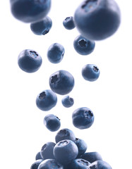 Wall Mural - Ripe blueberries levitate on a white background