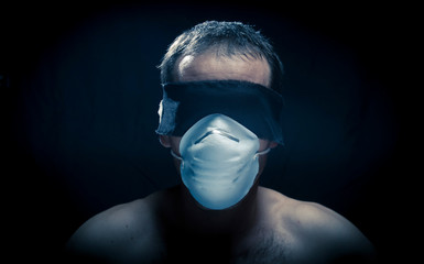 man head wearing blindfold and medical protective mask in black background