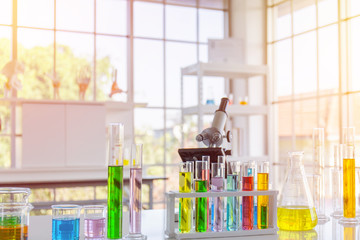 Poster - Chemical reagent in scientific experiment flasks of various shapes, sizes and with orange light.