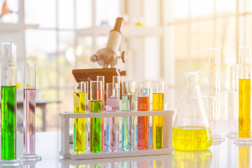 Poster - Chemical reagent in scientific experiment flasks of various shapes, sizes and with orange light.