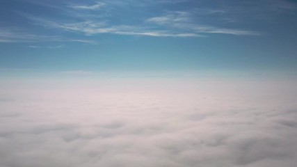 Wall Mural - Flight above the clouds at sunrise.