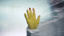 Protective glove with blood stain behind curtain in virus quarantine