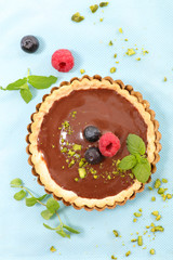 Poster - chocolate tart with berry fruit- top view