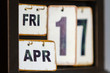 a calendar with interchangeable wooden tablets indicating the day of the week, month and day Friday April 17th.