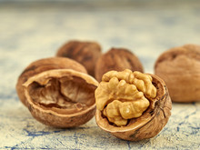 Walnut Kernels On A Dark Table With A Colored Background