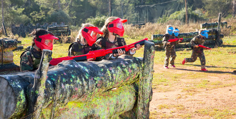 Wall Mural - Kids paintball players aiming outdoors