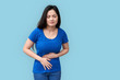 © Viktoriia - Young adult asian girl standing with spasm in stomach