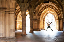  Silhouette Of Happy Girl Jumping High Up In Cloisters Of Glasgow University