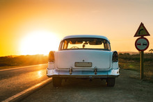 Baby Blue And White Classic Car On The Road At Sunset In Cuba