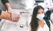 © Maridav - Corona virus protection methods to prevent spreading coronavirus in airport travel and public transport spaces. Asian woman wearing face mask versus man washing hands with soap hand hygiene.