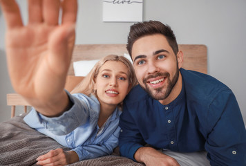 Poster - Young couple video chatting at home