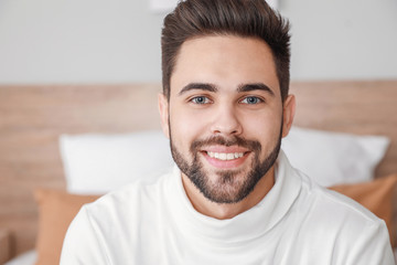 Wall Mural - Young man video chatting at home