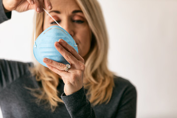 Virus: Woman Taking Precaution By Putting On Medical Mask