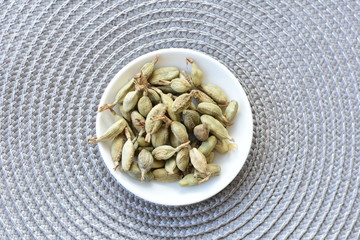 Dry cardamom seed (Elettaria cardamomum) displayed in containers