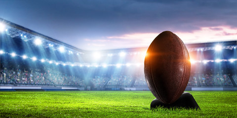 American football in stadium at night