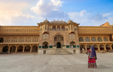 Wall Mural - Woman in traditional outfit at historic Amer Fort at Jaipur Rajasthan India