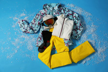 Stylish Winter Sport Clothes On Light Blue Background, Flat Lay