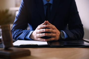 Wall Mural - Male lawyer at table in office, closeup