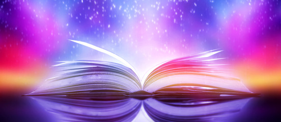 Poster - The blurred book that is bewitched with magic, the magic light in the dark, with the bright light shining down as the power to search for knowledge. For research and use as a blurred background