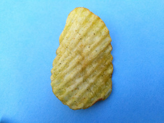 Wall Mural - a yellow potato chips eatable food isolated on sky blue background