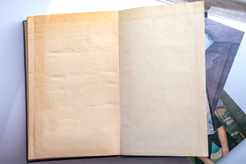 Old book with photos close-up, a book on a light background.