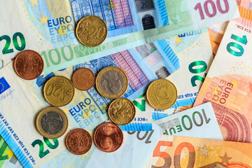 Background from euro banknotes and euro cents. World of money