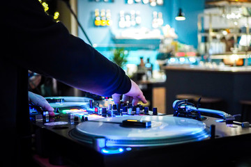 DJ vinyl players in dark nightclub, party in the dance club, DJ equipment, defocused	