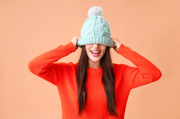 Sticker - Stylish young woman in warm clothes on color background