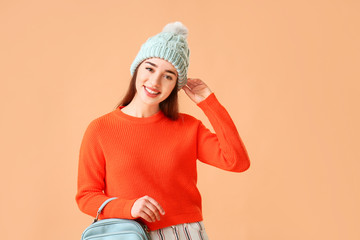 Sticker - Stylish young woman in warm clothes on color background