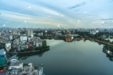 Wall Mural - Smart city and wireless communication network concept. Digital network connection lines of Hanoi city at West Lake or Ho Tay