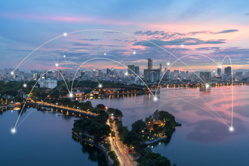 Wall Mural - Smart city and wireless communication network concept. Digital network connection lines of Hanoi city at West Lake or Ho Tay