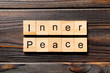 inner peace word written on wood block. inner peace text on table, concept