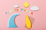 Fototapeta Dinusie - Top view of paper cut summer beach with surfboard and sunscreen on pink background