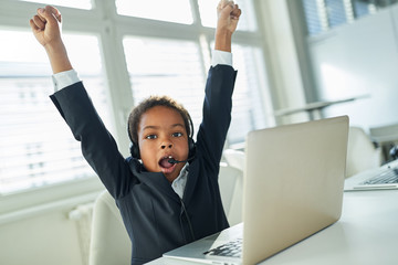 Cheering african boy as a businessman