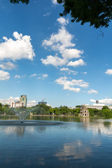 Wall Mural - Hoan Kiem lake or Sword lake, Ho Guom in Hanoi, Vietnam with Turtle Tower, on clear day with blue sky and white clouds