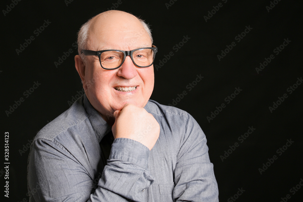 Portrait of elderly man on dark background