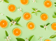  Slices Of Orange Fruit And Blossom With Leaves.