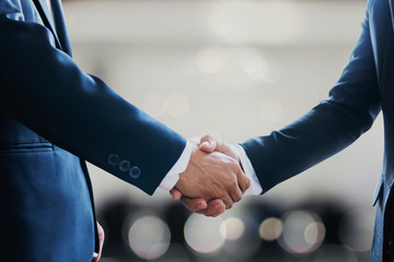 Wall Mural - successful contract negotiate and handshake concept, two businessman shake hand with partner to celebration partnership, teamwork, business deal in room meeting after success communication, agreement