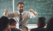 © MYDAYcontent - Enthusiastic math teacher explaining subject to students gesticulating with hands in schoolroom