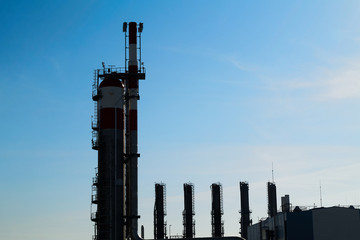 Oil and gas refinery industrial plants with silhouette image. Chemical plant in backlight wuth copyspace.